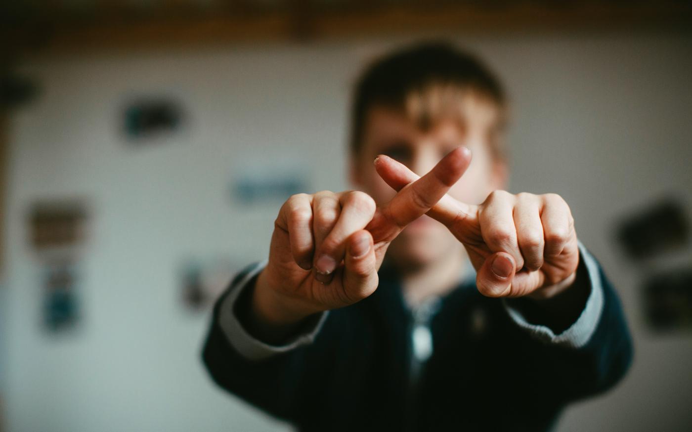 man in black and white jacket doing peace sign by Markus Spiske courtesy of Unsplash.