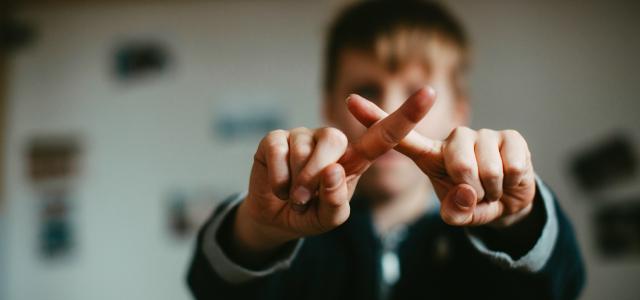man in black and white jacket doing peace sign by Markus Spiske courtesy of Unsplash.